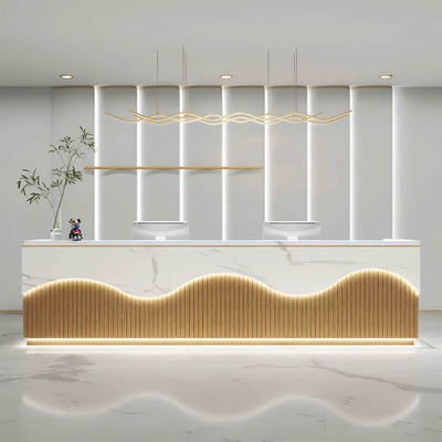Office reception desk front view with a marble-look wave panel and warm lighting
