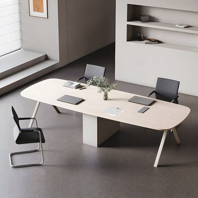 Small rounded conference table with four chairs in a meeting room