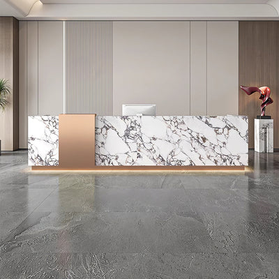 Lobby reception desk front view with white marble-look and gold panels