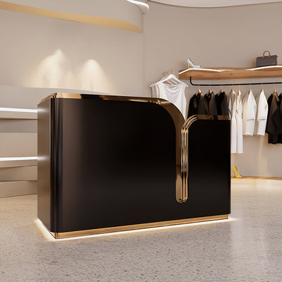 Clothing store checkout counter angled front view with a black curved counter and gold trim