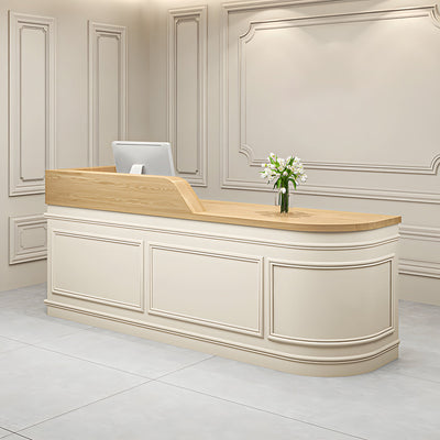 Boutique reception desk angled front view with classic cream panelling and a curved end