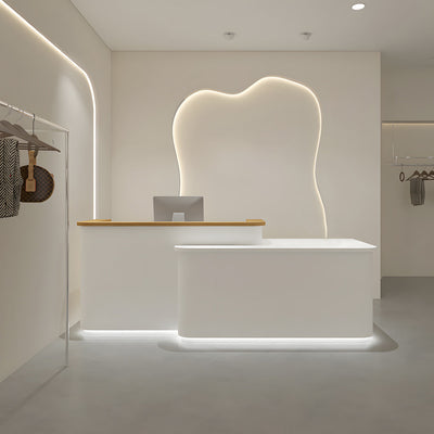 Clothing store checkout counter angled front view with a small white counter and timber worktop